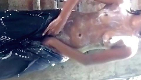 Indian girl has fun while getting rainwater inside