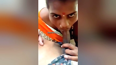 Brunette babe is giving a blowjob to a guy outdoors