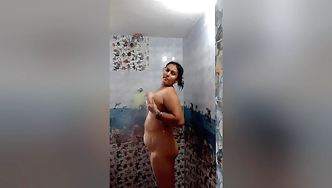 Indian mature woman in a hot bed taking shower outdoors