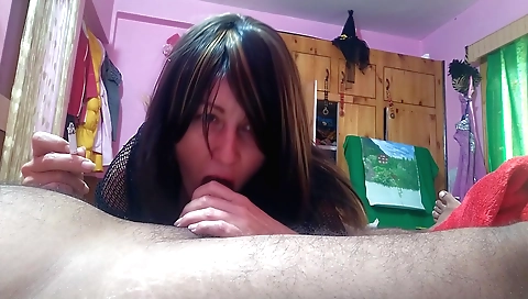 Indian girl smokes and blows a cock in front of a webcam
