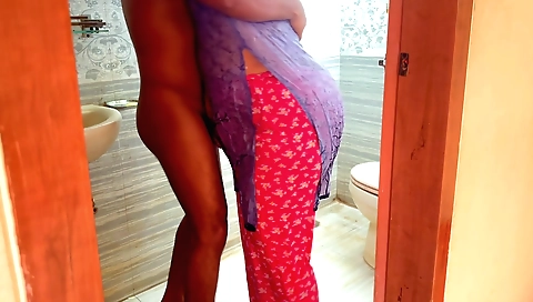 Indian milf in a long black dress masturbates in the bathroom