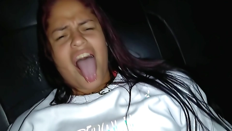 A brunette with big natural tits is having fun in the taxi