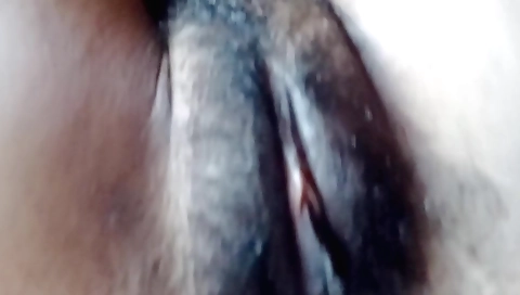 Indian hairy lady in bed gets naked and masturbates